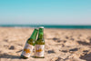 Two Beer Bottles Mockup At The Beach Psd