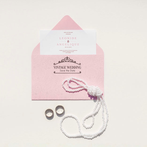 Wedding Decoration In Pink Tones With Envelope And Wedding Rings Psd