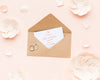 Wedding Rings And Invitation Mock-Up With Paper Flowers And Petals Psd