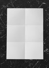 White Folded Paper On Marble Mockup Psd