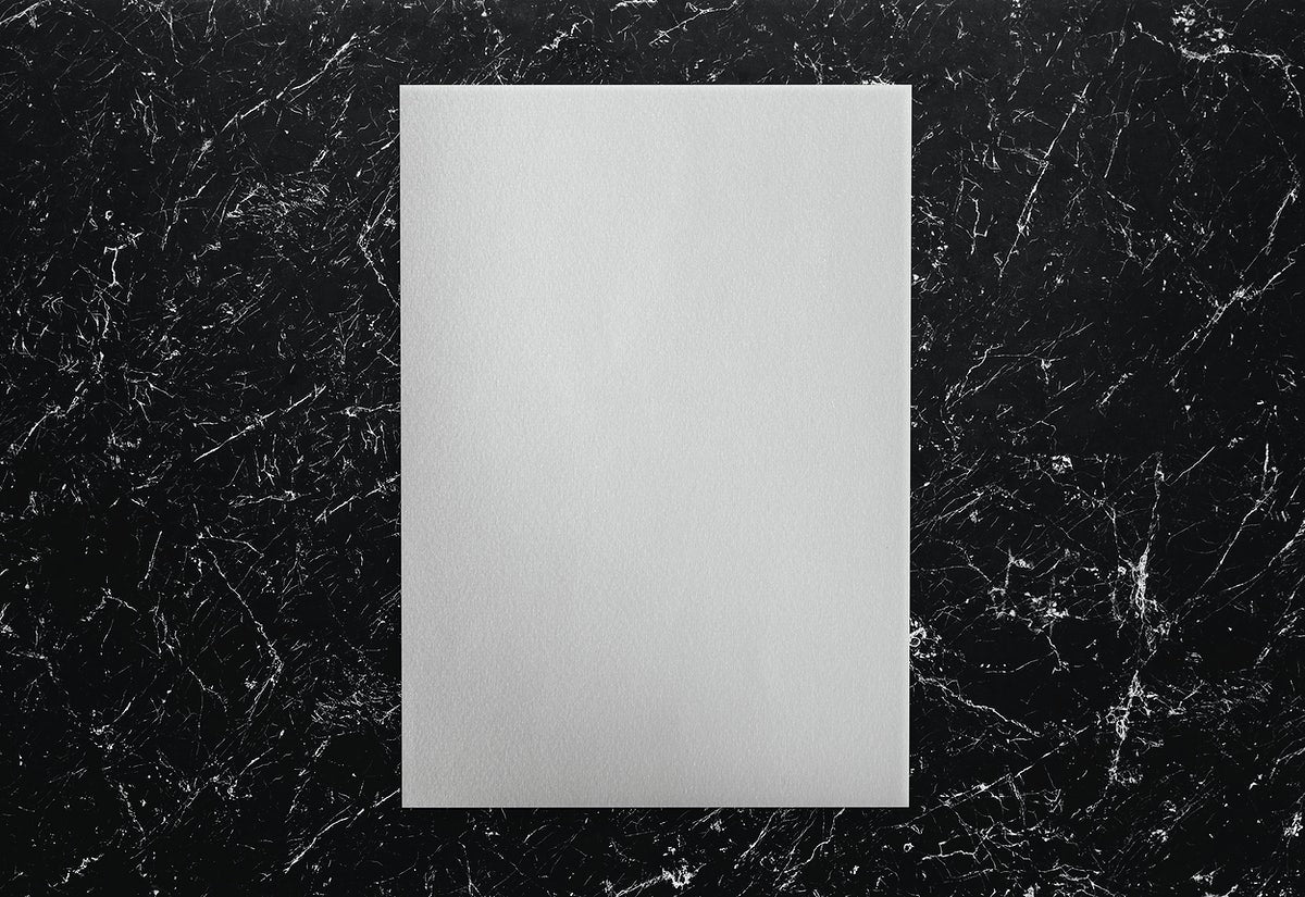 White Paper On A Black Marble Background