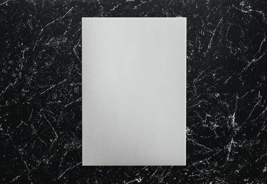 White Paper On A Black Marble Background