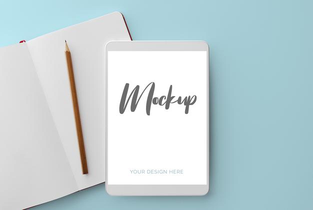 White Tablet On Blue With Notebook And Pencil Mockup Psd