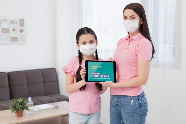 Woman And Daughter Holding A Tablet Mock-Up With Covid-19 Presentation Psd