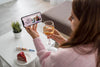Woman Celebrating At Home With Friends Over Smartphone And Drink Psd