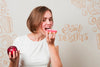 Woman Eating A Donut And An Apple Psd