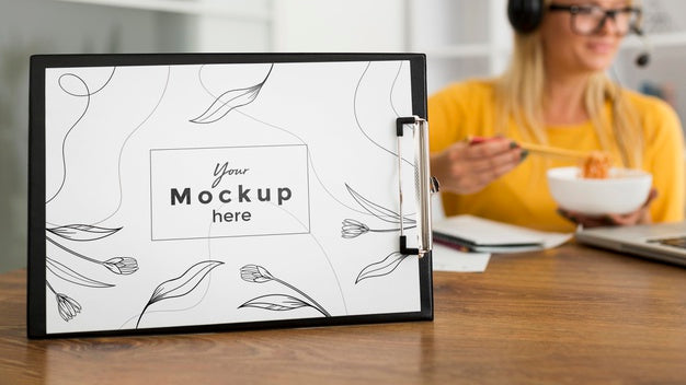 Woman Eating At Desk With Clipboard Mock-Up Psd