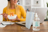 Woman Eating At Desk With Disinfectant Mock-Up Psd