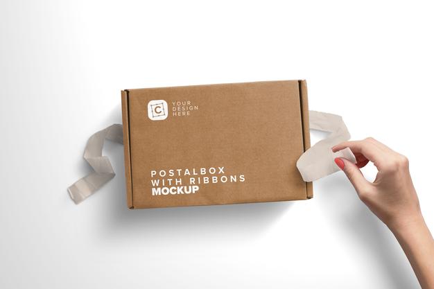 Woman Hand Opening Postal Box With Ribbons Mockup Psd