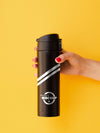 Woman Holding A Black Thermos Mock-Up On Yellow Background Psd