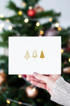 Woman Holding A Christmas Card In Front Of A Christmas Tree Mockup Psd
