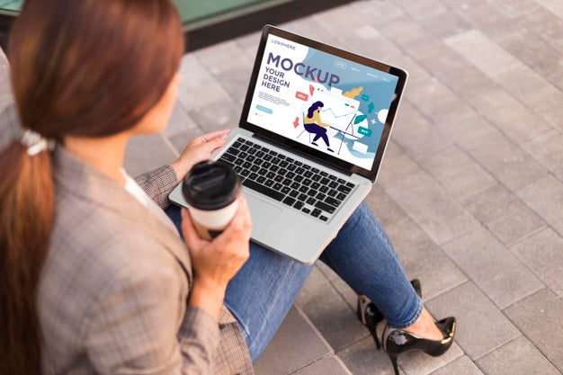 Woman Holding A Mock-Up Laptop Outdoors Psd