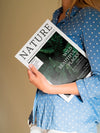 Woman Holding A Nature Magazine Close To Her Chest Psd
