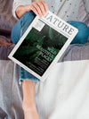 Woman Holding A Nature Magazine Next To Her Leg Psd