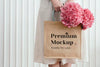 Woman Holding A Woven Tote Bag Mockup With Pink Hydrangea Flowers Psd