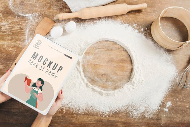 Woman Holding Book In The Kitchen With Flour And Sieve Psd