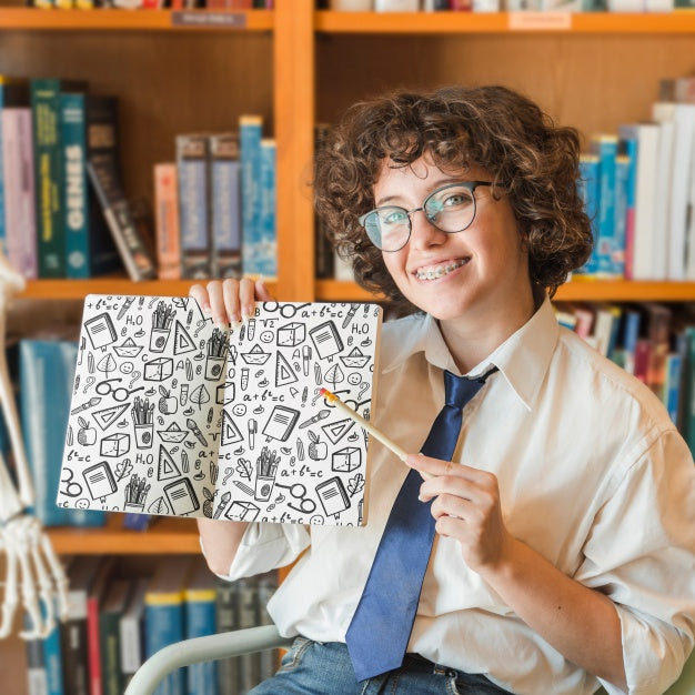Woman Holding Book Mockup In Library Psd