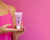 Woman Holding Cream Bottle Mock-Up With Copy Space Psd