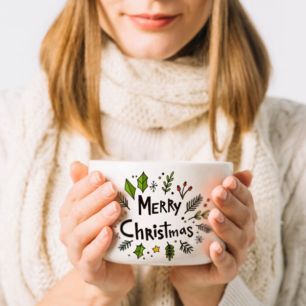 Woman Holding Cup Mockup With Christmas Concept Psd