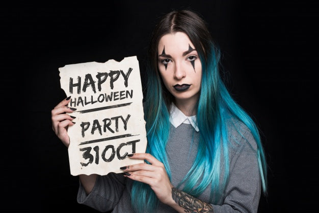 Woman Holding Paper With Halloween Lettering Psd