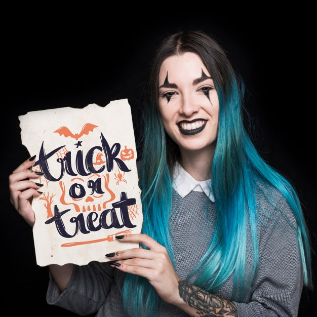 Woman Holding Paper With Halloween Lettering Psd
