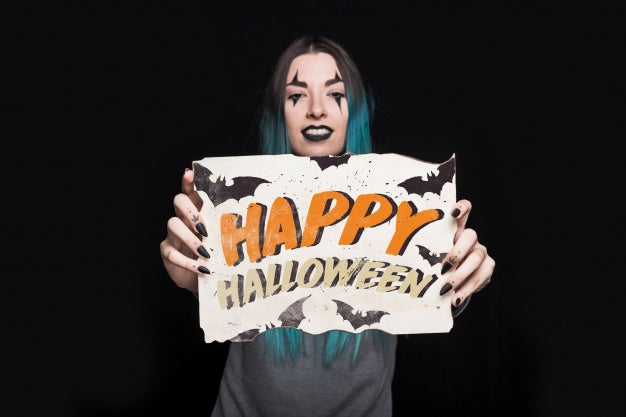 Woman Holding Paper With Halloween Lettering Psd