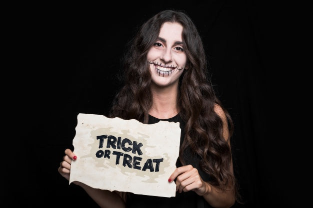 Woman Holding Paper With Halloween Lettering Psd