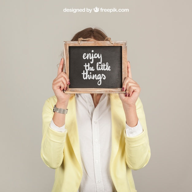 Woman Holding Slate In Front Of Face Psd