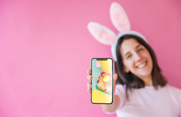 Woman Holding Smartphone Mockup For Easter Psd