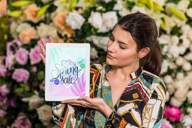 Woman Holding Tablet Mockup For Spring Sale Psd