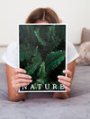Woman In Bed Holding A Nature Magazine Psd