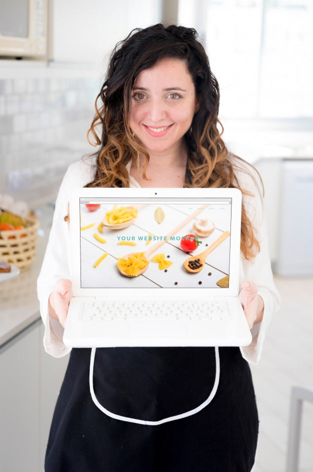 Woman In Kitchen Presenting Laptop Mockup Psd