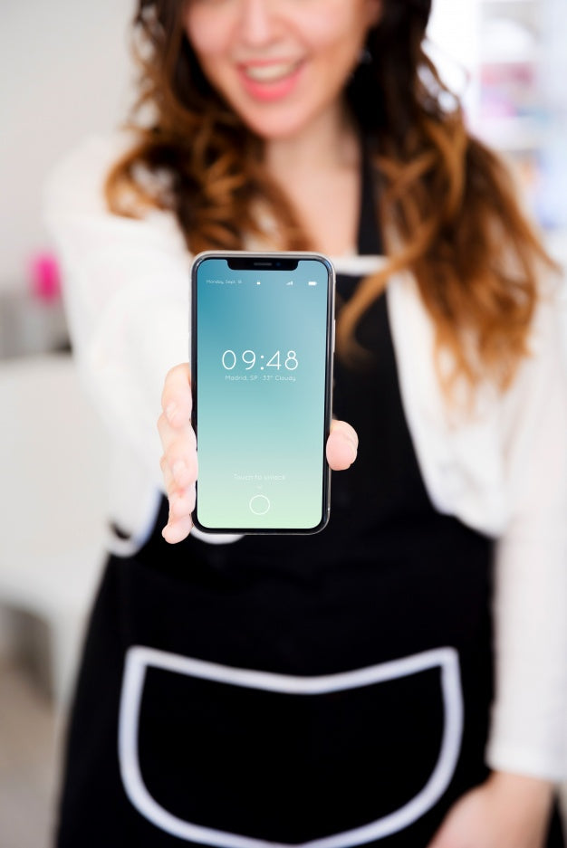 Woman In Kitchen Presenting Smartphone Mockup Psd
