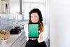 Woman In Kitchen Presenting Tablet Mockup Psd
