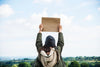 Woman In Nature Holding Cardboard Psd