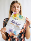 Woman Looking At Camera And Showing A Mock Up Magazine Psd