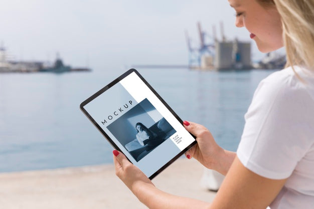 Woman On Street Reading Book On Tablet Psd