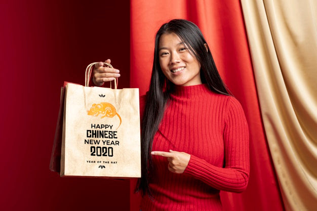 Woman Pointing At Bag With Happy New Year Message Psd