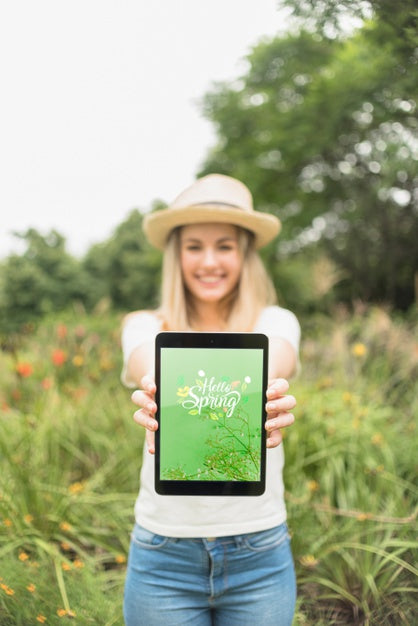 Woman Presenting Tablet Mockup In Nature Psd