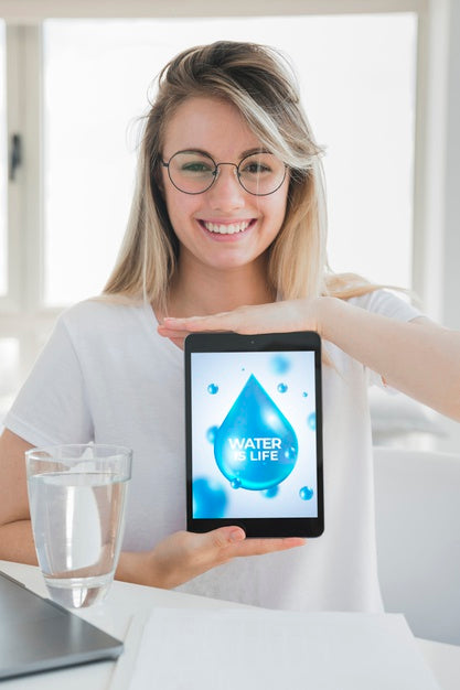 Woman Presenting Tablet Mockup With Water Concept Psd