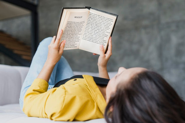 Woman Reading From A Mock-Up Book Psd