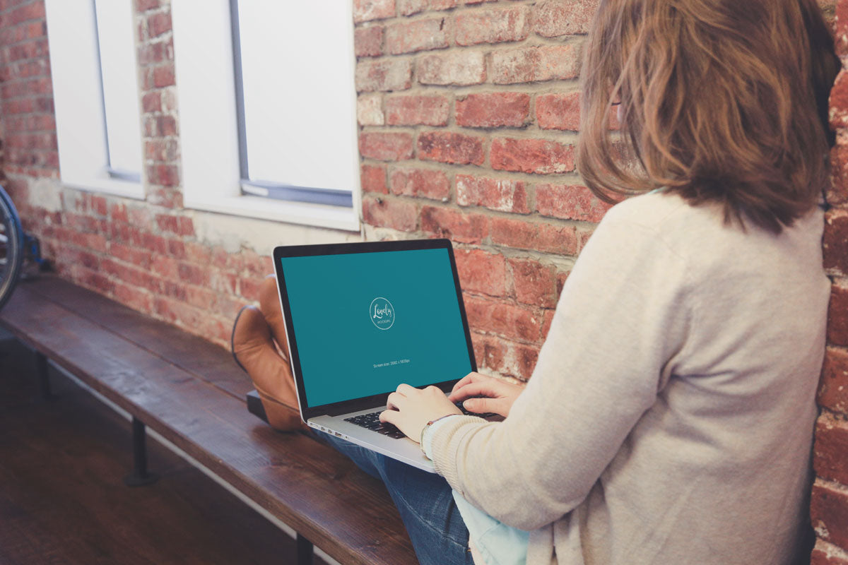 Woman Sitting with Macbook on Her Knees PSD Mockup