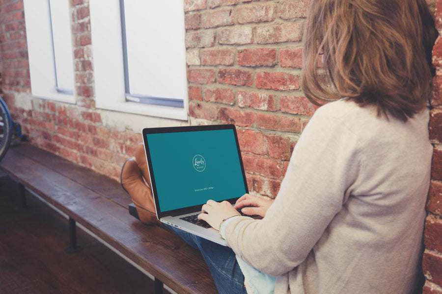 Woman Sitting with Macbook on Her Knees PSD Mockup