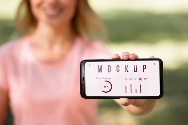 Woman Showing A Phone With A Mock-Up Screen Outdoors Psd