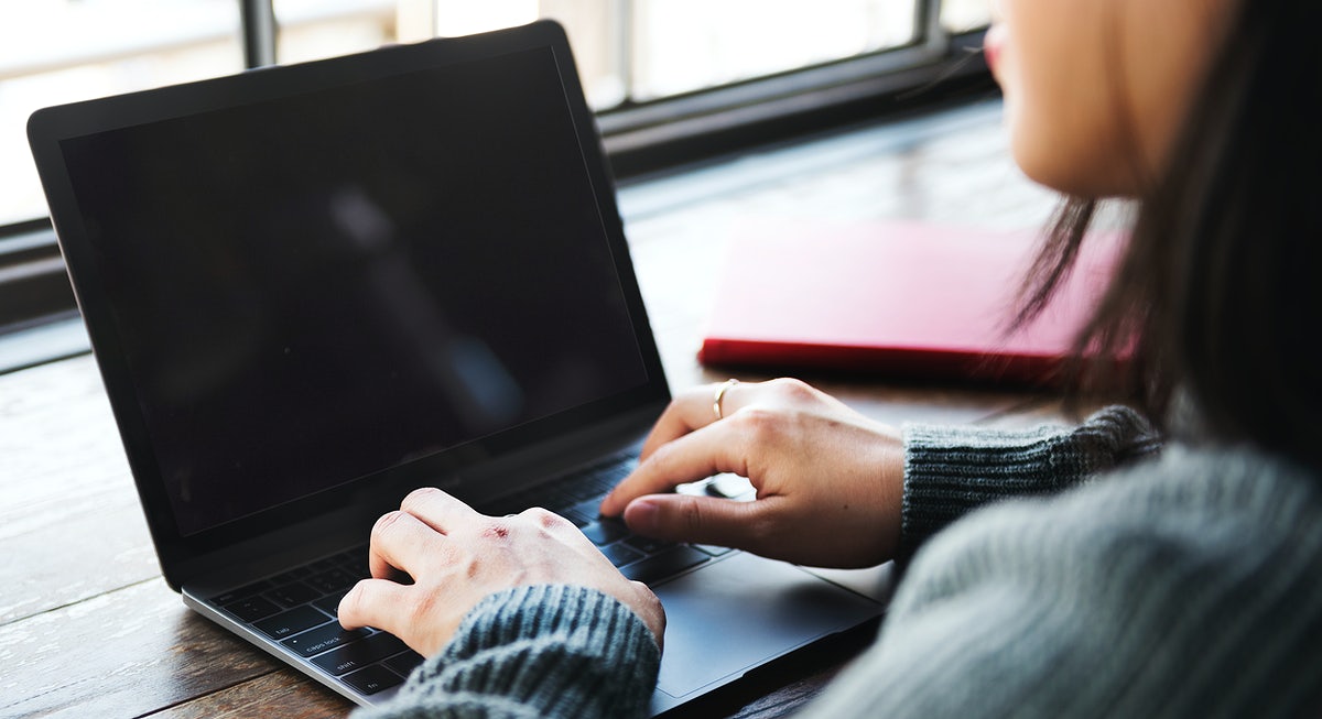 Woman Using A Laptop With An Empty Screen