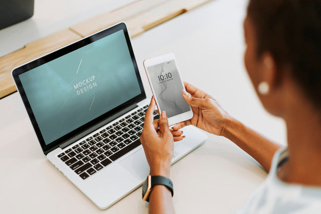 Woman Using Laptop And Smartphone Psd