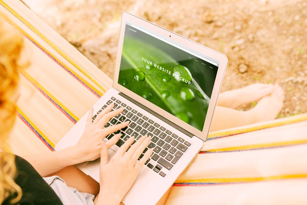 Woman Using Laptop Mockup In Nature Psd