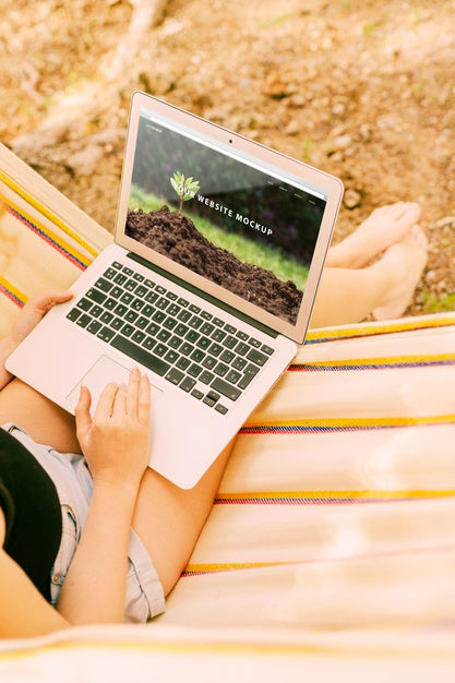 Woman Using Laptop Mockup In Nature Psd