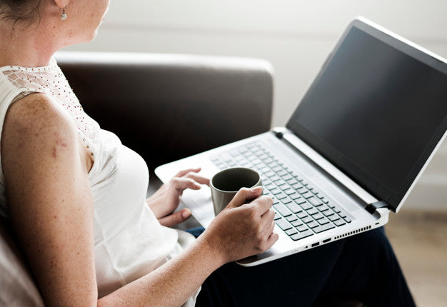 Woman Using Laptop On Sofa Psd