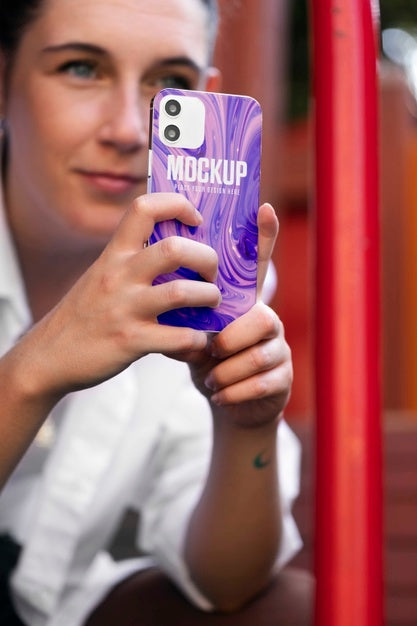 Woman Using Mock-Up Smartphone Outdoors To Take Picture Psd
